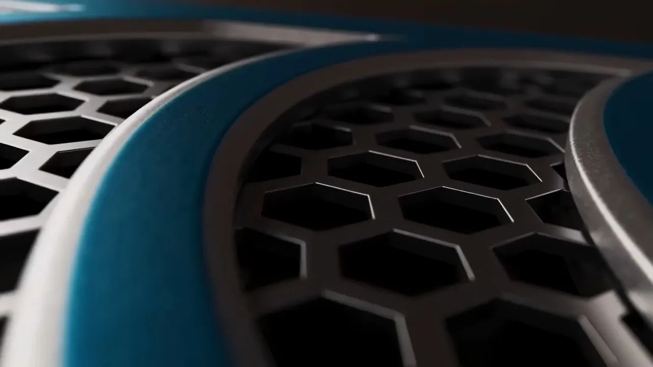 A close crop of the Cylake appliance's front grille, its hexagonal mesh turning slowly under a hard light.